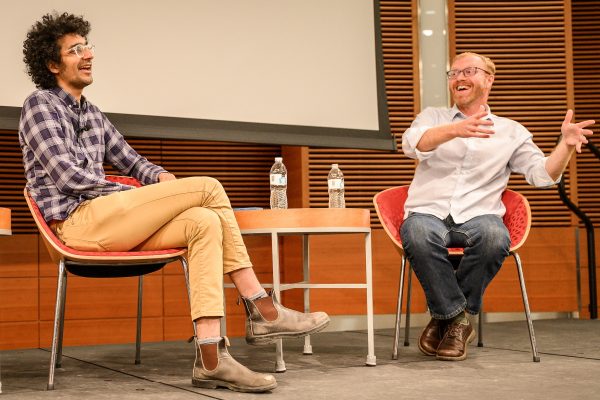 From left to right, Latif Nasser, Radiolab host and UW–Madison Science Journalist in Residence, and Soren Wheeler, Radiolab’s executive editor and a previous UW–Madison Science Journalist in Residence, laugh together on stage as they discuss story ideas that Wheeler has nixed during a Wisconsin Science Festival and Crossroads of Ideas event called “How to Hunt for Stories, and Not Kill Them in the Telling” in the Discovery Building at the University of Wisconsin–Madison on Oct. 13, 2022. (Photo by Althea Dotzour / UW–Madison)